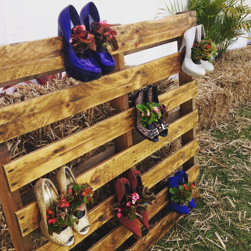 a colourful display of shoes used as wall planters